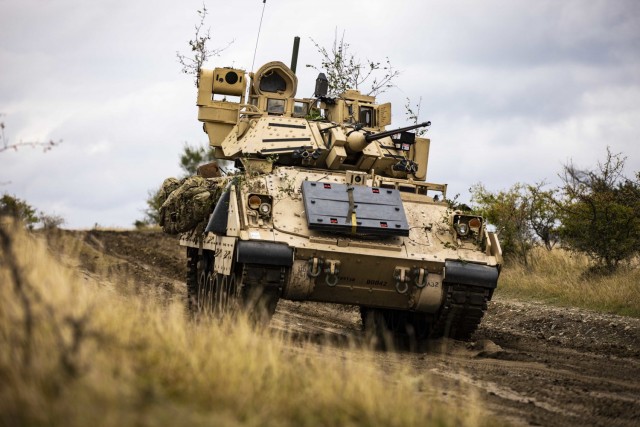 A M2 Bradley Infantry Fighting Vehicle assigned to 1st Battalion, 16th Infantry Regiment “Iron Rangers,” 1st Armored Brigade Combat Team, 1st Infantry Division moves  toward an objective during a multinational situational training exercise in...