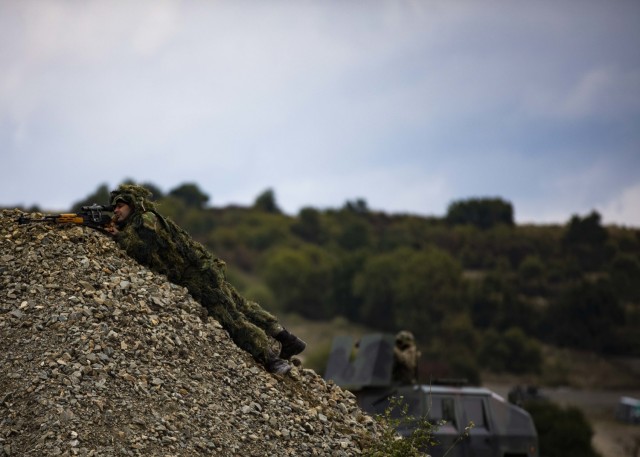 A Romanian sniper aims down his sights during a multinational situational training exercise in Cincu, Romania, Sept. 23, 2021. The training incorporated Soldiers from Poland, Romania and Portugal, and enhanced the interoperability between the NATO...