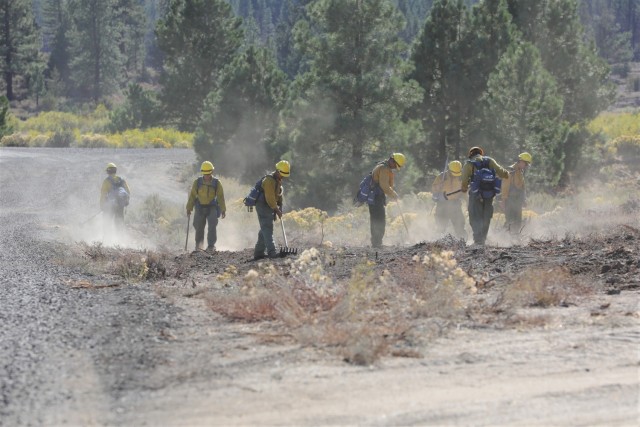 U.S. Army Soldiers from the 2-3 Infantry Battalion, 1-2 Stryker Brigade Combat Team, assigned to Joint Base Lewis-McChord, Washington, use their tools and boots to level native tribal land as part of recovery operations while deployed in support of the Department of Defense wildland firefighting response operations on the Dixie Fire in Plumas National Forest, California, Sept. 19, 2021. U.S. Army North, U.S. Northern Command’s Joint Force Land Component Command remains committed to providing flexible DoD support to the National Interagency Fire Center to respond quickly and effectively to assist our local, state, and federal partners in protecting people, property, and public lands.