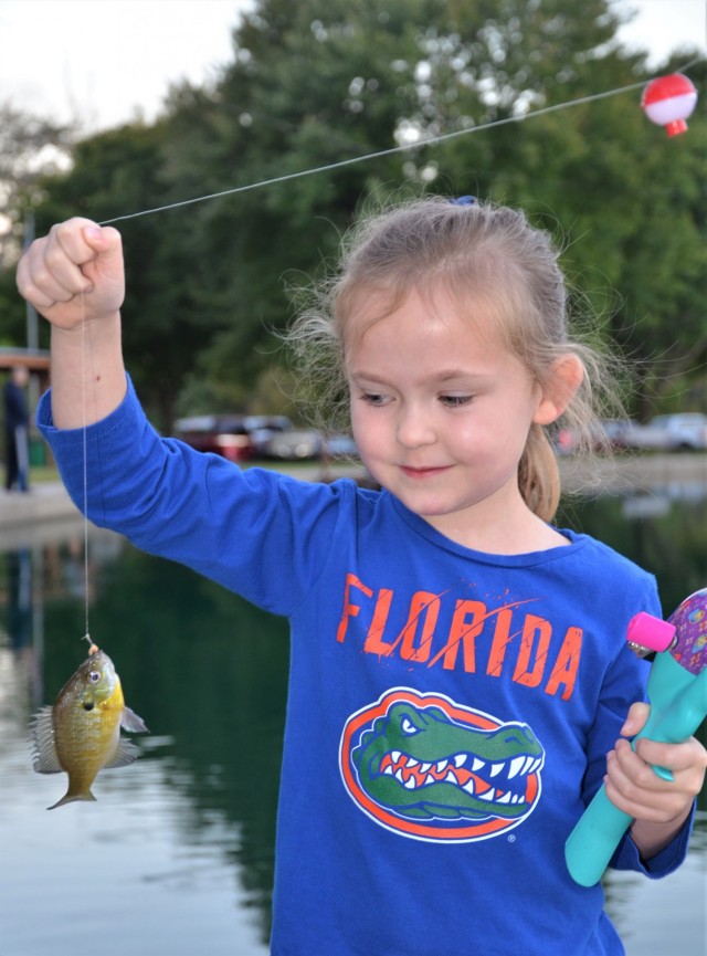 Catherine Burnley, 6, checks out her catch at the Fatherhood Fishing Derby at Rock Island Arsenal, Illinois, Sept. 23.