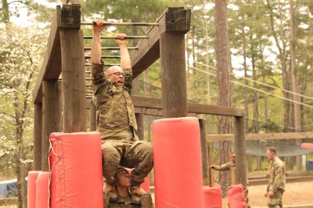 Spc. Daniel P. Bush Jr., a civil affairs specialist with the 418th Civil Affairs Battalion, and Staff Sgt. Natalie N. Tedesco, a psychological operations specialist with the 303rd Psychological Operations Company, go through the confidence course...