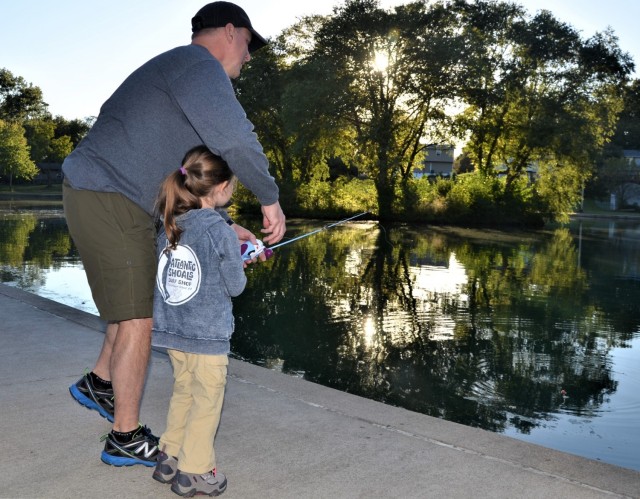 Catching the last bit of daylight, participants at the Fatherhood Fishing Derby at Rock Island Arsenal, Illinois, Sept. 23, get in a few more casts before the sun goes down.