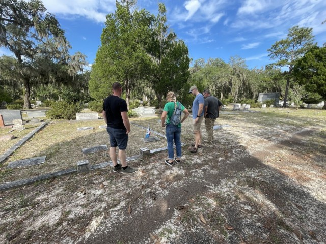 From the left, Capt. Jeremiah D. Worker, 1st Lt. Jill E. Bottarini, 1st Lt. Matthew C. Johnson and Sgt. 1st Class Eliot D. Bray place a flag at the gravesite of an EOD technician on Bonaventure Cemetery in Thunderbolt, Georgia.  Johnson coordinated the visit to four cemeteries in eastern Georgia.  U.S. Army photo by Alyssa Johnson.