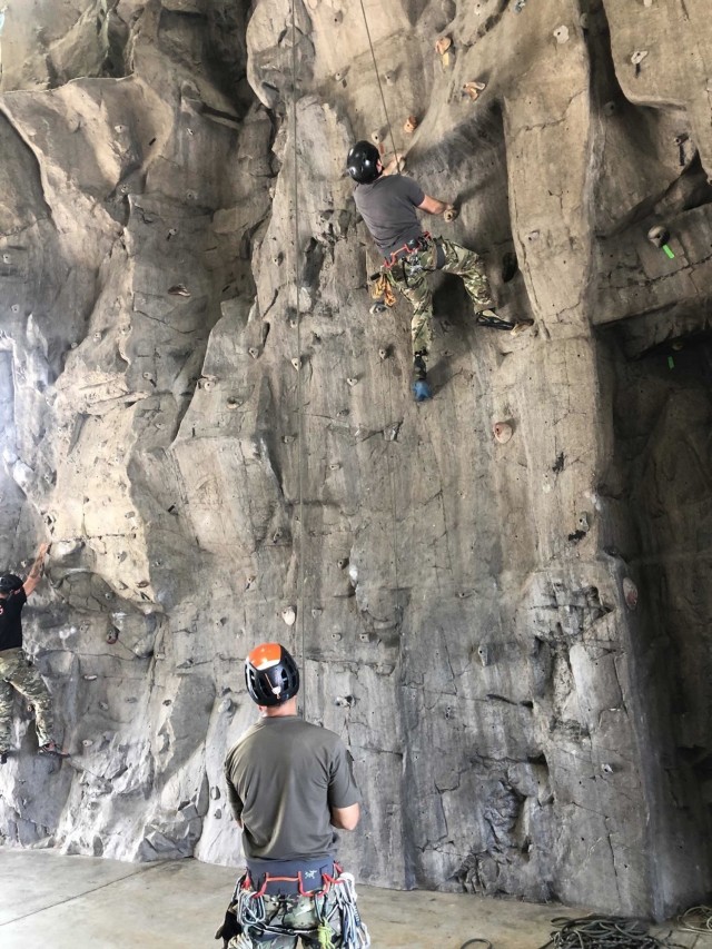 OKINAWA, Japan - U.S. Army Green Berets with 1st Battalion, 1st Special Forces Group (Airborne) train on a rock-climbing wall during the Basic Military Mountaineering Course held Sept. 7-16, 2021.  During the course, Soldiers develop skills ranging from tying basic knots to practicing Tyrolean traverse methods throughout varying terrain and obstacles. (U.S. Army Courtesy Photo)