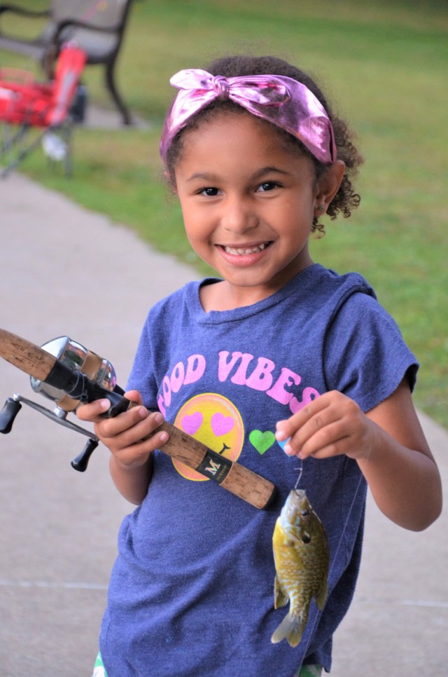 Aurora Callender, 5, was happy with her first catch of the day at the Fatherhood Fishing Derby at Rock Island Arsenal, Illinois, Sept. 23.