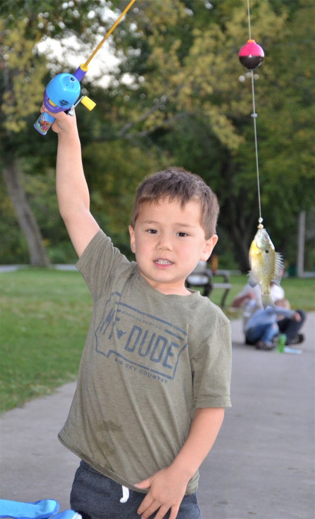 Nolan Kaizer, 4, shows off his finned friend at the Fatherhood Fishing Derby at Rock Island Arsenal, Illinois, Sept. 23.