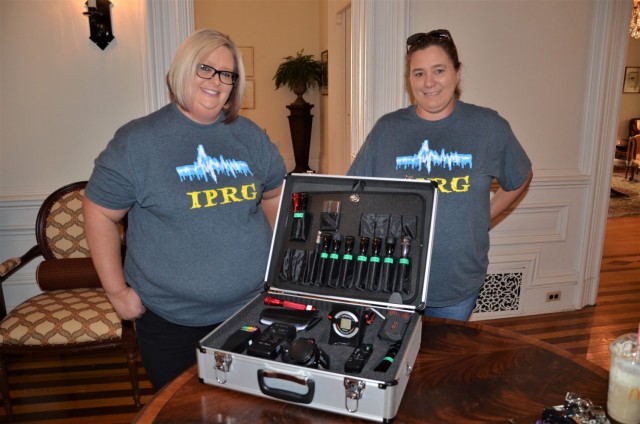 Cheryl Torres (left) and Amy Lefler of the Illinois Paranormal Research Group stand in the first floor hallway of Rock Island Arsenal, Illinois’ historic Quarters One with some of the many tools they use during their paranormal investigations....