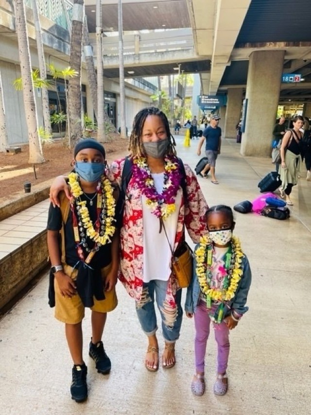 Sgt. First Class LaShonda Bryant poses with her children upon arrival to Hawaii. Bryant's sponsor, Master Sgt. Gloria Yaport, presented the Bryant family with leis at the airport to welcome them to Hawaii and the 402nd Army Field Support Brigade....