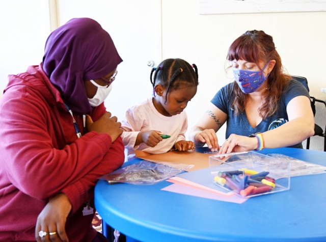 Angie Sonrode, playgroup leader for Parenting Connection of Monterey County, helps Jameelah Zagre, almost 3, with an art project during the weekly playgroup at Army Community Service, Ord Military Community, Calif., Sept. 28. Jameelah’s mother,...