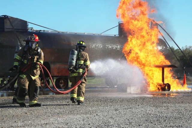 Firefighter Jerome Amos and Lt. Taylor Hennerfeind, Clarksville Fire Rescue, put out a wheel assembly fire during an International Fire Service Accreditation Congress Airport Firefighter course hosted Sept. 20-24 at Fort Campbell. Fort Campbell Fire and Emergency Services partnered with the Tennessee State Fire Commission to help approximately 14 firefighters earn their Airport Firefighter certification through the 40-hour program, which included classroom instruction and hands-on training.