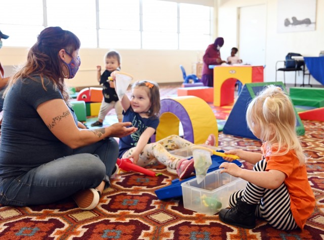Angie Sonrode, playgroup leader for Parenting Connection of Monterey County, plays with children during the weekly playgroup at Army Community Service, Ord Military Community, Calif., Sept. 28.