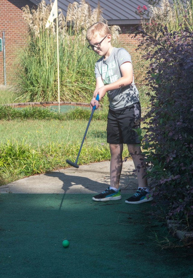 Families enjoyed a round of mini golf, free of charge, at Palmetto Mini Golf during the Pawesome Flea Market Sept. 18, 2021 at the Solomon Center, Fort Jackson, S.C. Jackson Geiser tees off during a mini golf game with his Family while enjoying the shade from the sunny morning heat.