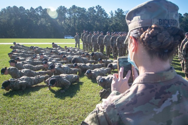 Staff Sgt. Leah J. Bickford, right, watches as her son’s platoon performs push-ups after completing their Basic Combat Training graduation ceremony Sept. 23, 2021, at Fort Jackson, S.C. Bickford was attending a Senior Leaders Course at the...