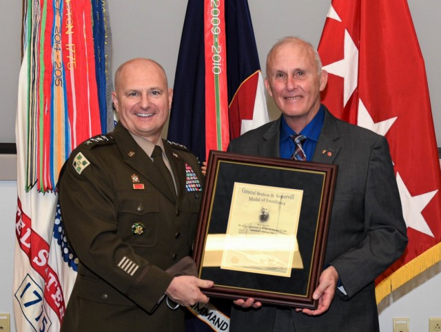 Gen. Ed Daly (left), Army Materiel Command commanding general, presents Nathan Godwin (right) with the Gen. Brehon B. Somervell Medal of Excellence award. Godwin retired after more than 50 years of service. (U.S. Army photo by Javier Otero)