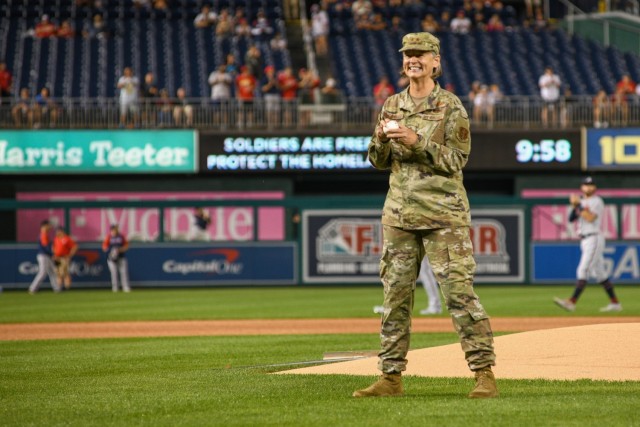 U.S. Air Force Maj. Gen. Sherrie McCandless, District of Columbia National Guard interim commanding general, prepares to throw the ceremonial first pitch at the Washington Nationals baseball game Aug. 13, 2021, as a part of the team’s National...