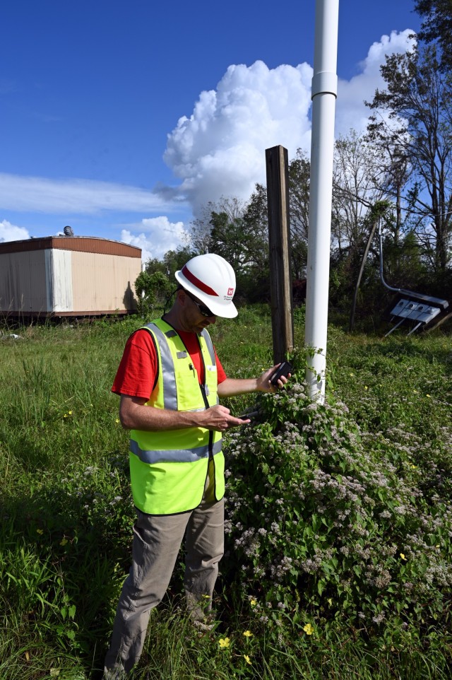 Matt Clark, U.S. Army Corps of Engineers, St. Paul District, project scheduler currently deployed to New Orleans, Louisiana, in support of Hurricane Ida recovery efforts, gathers technical data during a site inspection in Edgard, Louisiana, Oct....