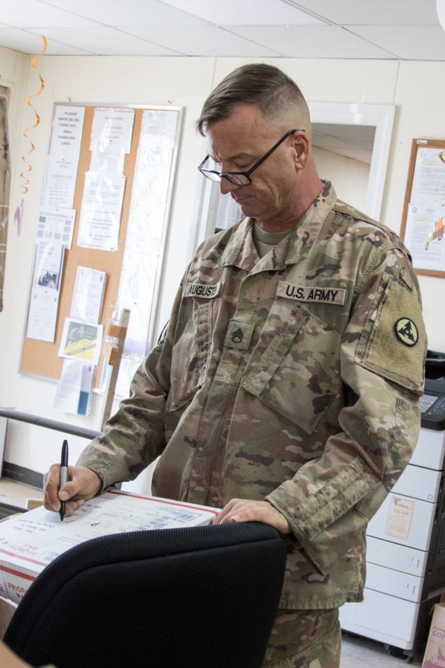 Staff Sgt. Steven W. Augusten, the postal officer noncommissioned officer in charge for Headquarters and Headquarters Company, 3rd Expeditionary Sustainment Command, marks a parcel before placing it in the mail room at Camp Arifjan, Kuwait, on Oct. 2, 2021. Augusten, a native of Dayton, Ohio, has been serving as a postal officer NCOIC since he deployed to Kuwait with the 310th Expeditionary Sustainment Command in December of 2020 to staff the 1st Theater Sustainment Command Operational Command Post.