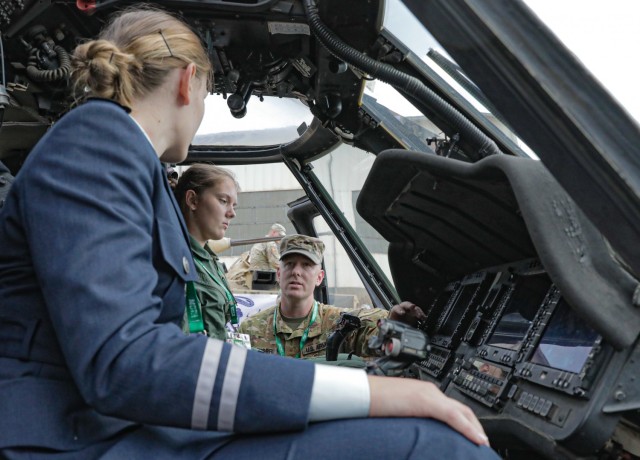 Chief Warrant Officer 2 Adam Meuser, a UH-60 Black Hawk helicopter pilot assigned to 3rd Assault Helicopter Battalion, 1st Aviation Regiment, 1st Combat Aviation Brigade, 1st Infantry Division, explains functions of the Black Hawk to members of...