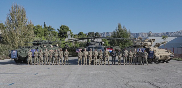 Members of the 1st Infantry Division and 7th Army Training Command gather with Anthony Sebrell, the armaments cooperation and trade show coordinator for U.S. Army Europe and Africa, during the Adriatic Sea Defense and Aerospace exhibition in...
