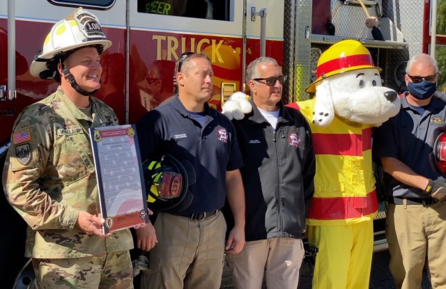 (left) Col. Jarrod  Moreland holds the Fire Prevention Week proclamation he signed along with other officials from the Fort Huachuca Fire Department.