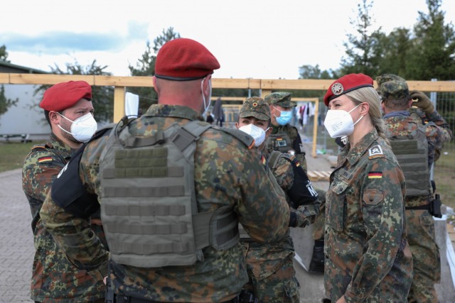 German Bundeswehr HptFw Sandra Born (right) with liaison Detachment BwLOGCOM, 21st Theater Sustainment Command, discusses plans for Operation Allies Welcome at Rhine Ordnance Barracks in Kaiserslautern, Germany, Sept. 30, 2021. The German Armed...