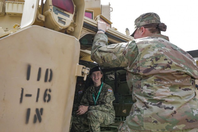 U.S. Army Sgt. Victoria Bridgen (right), a Bradley Fighting Vehicle system maintainer assigned to 1st Battalion, 16th Infantry Regiment, 1st Armored Brigade Combat Team, 1st Infantry Division, explains the capabilities of the M2A3 Infantry...