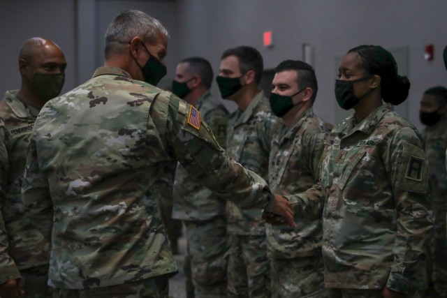 Chief Warrant Officer 3 Quintamaria Weeks, a Soldier assigned to 188th Infantry Brigade, receives a challenge coin from Maj. Gen. Charles D. Costanza, commander of the 3rd Infantry Division, Oct. 6, 2021, on Fort Stewart, Georgia, for her support...