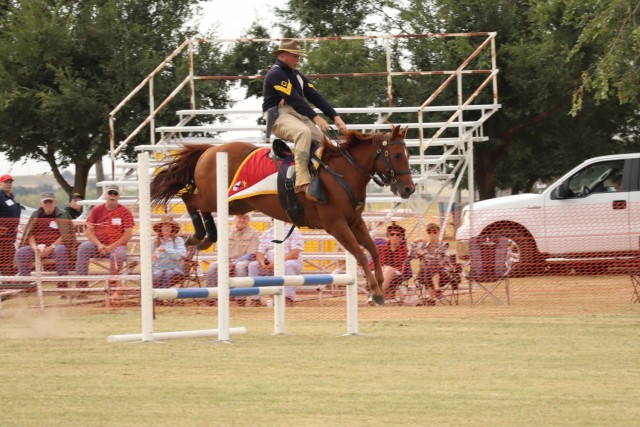 Garry Owen, ridden by Sgt. 1st Class Chris Stemple, Non-commissioned officer in charge of Horse Detachment, Regimental Headquarters and Headquarters Troop, 11th Armored Cavalry Regiment, jumps over a set of beams at the National Cavalry Competition, Fort Reno, Oklahoma, on September 24, 2021. Field jumping increases the mobility of the horse/rider pair.