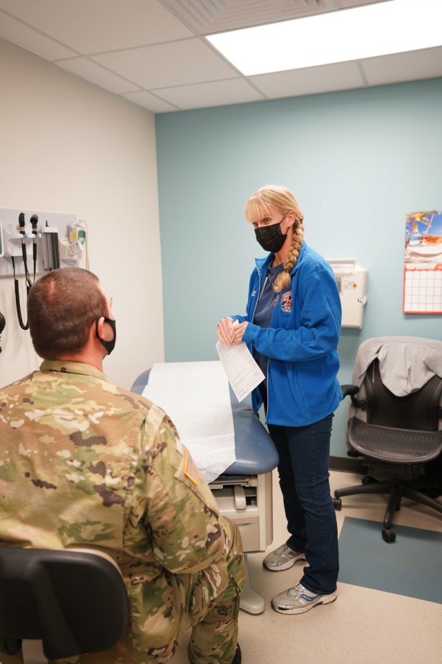 Martin Army Community Hospital's Department of Warrior Care Physician Assistant Jennifer Wampler explains treatment to a patient at Winder Clinic.