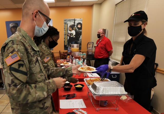 Soldiers enjoy tasting different new dining facility menu options Oct. 5, 2021 and fill out comment cards to express their thoughts about each one.