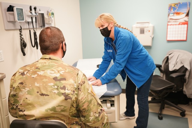 Martin Army Community Hospital's Department of Warrior Care Physician Assistant Jennifer Wampler examines a patient at Winder Clinic.