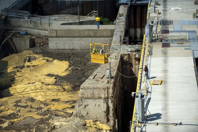 Contractors use a man basket to remove items from the old lock wall inside the new chamber at Charleroi Locks and Dam on the lower Monongahela River in Pennsylvania, Sept. 30, 2021. The U.S. Army Corps of Engineers Pittsburgh District recently...