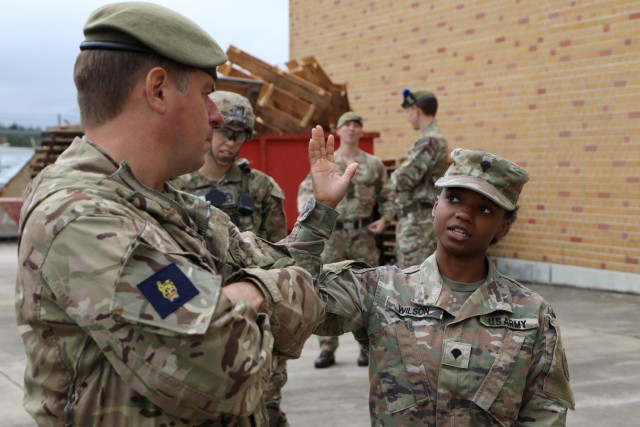 Brigadier Sam Humphris (left), commander of the 1st Armoured Infantry Brigade (UK), and Spc. Asia Wilson, 3rd Squadron, 2d Cavalry Regiment, discuss the Integrated Tactical Network&#39;s performance during Saber Junction 21. The 1st Armoured...