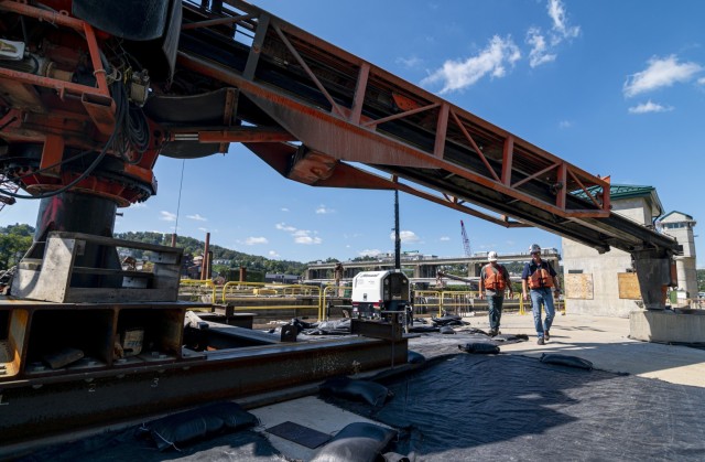 Kirk McWilliams and Shawn Soltis, resident and field engineers for the U.S. Army Corps of Engineers Pittsburgh District, walk underneath a swinger used for concrete pouring at the construction project at Charleroi Locks and Dam on the lower...