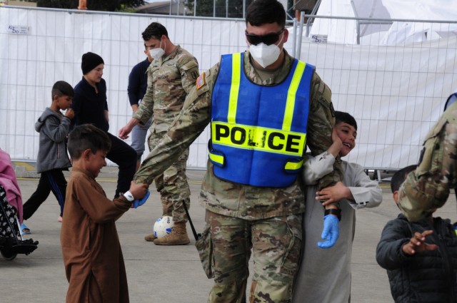 Soldiers assigned to 1st Battalion, 77th Field Artillery Regiment, play with Afghan children in the courtyard at Ramstein Air Base, Germany while conducting gate guard and security patrols in the facilities on Sept. 30, 2021. Approximately 175...