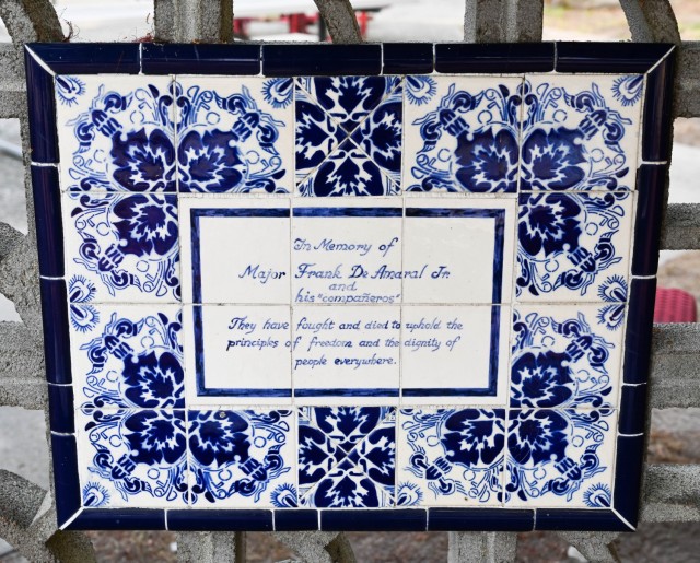 A title plaque at the fountain reads: “In memory of Major Frank De Amaral Jr., and his Companeros. They have fought and died to uphold the principles of freedom and the dignity of people everywhere.”