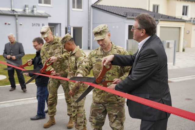 From left to right, Mr. Roman Beer, Col. Christopher Danbeck, Command Sgt. Maj. Sebastian Camacho, Col. Patrick Dagon, and Vilseck Mayor Hans-Martin Schertl cut a ribbon to signify the completion of 15 newly constructed homes at Rose Barracks,...