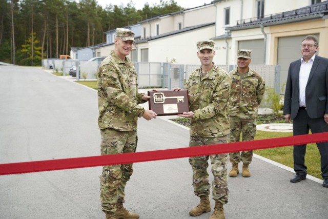 Col. Patrick Dagon (right), the U.S. Army Corps of Engineers Europe District commander, presents U. S. Army Garrison Bavaria Garrison Command Col. Christopher Danbeck with a symbolic key to the neighborhood during a ribbon-cutting ceremony at Rose...