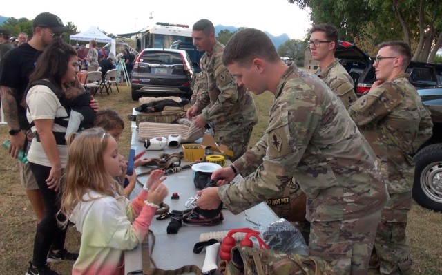 Soldiers from the 483rd Military Working Dog Detachment demonstrate equipment at the National Night Out Event at Veterans Memorial Park in Sierra Vista, Ariz.