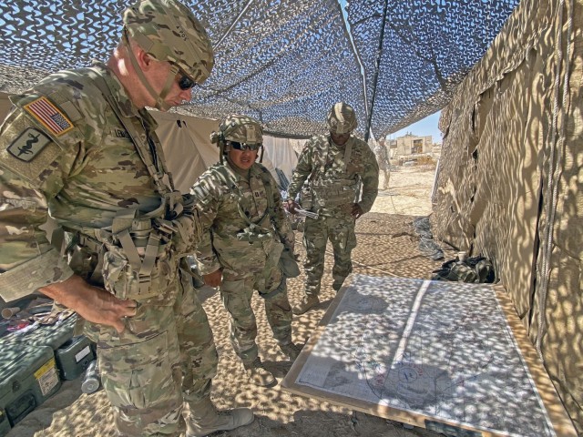 Maj. Gen. Dennis P. LeMaster reviews a map during a briefing while at the National Training Center, Fort Irwin, California.