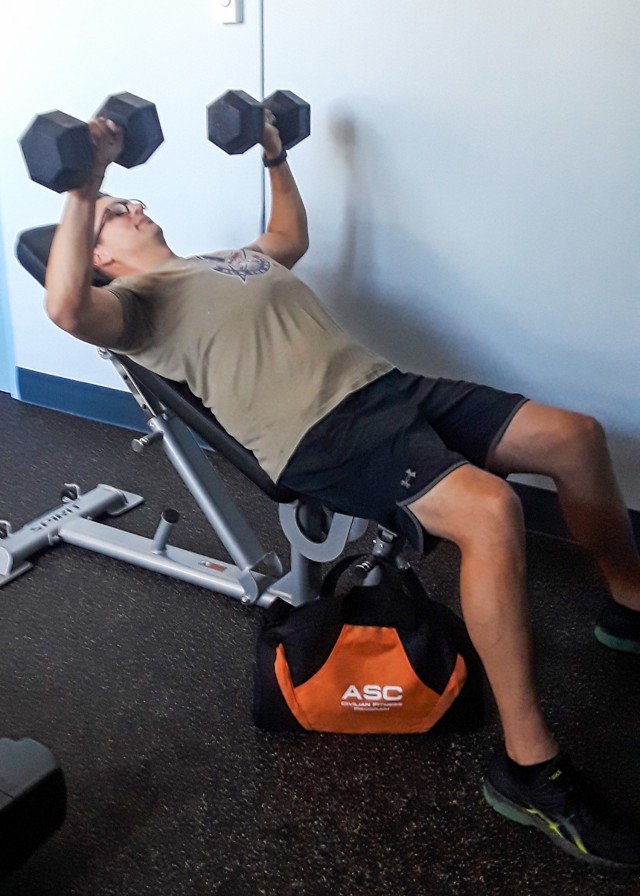 Nick Osterhaus, Wellness Program Specialist for the US Army Maintenance Command, does weight training during the Citizens Fitness and Wellness Program on Sept. 28.  (Photo by Linda Ottman, G1 Division, ASC)