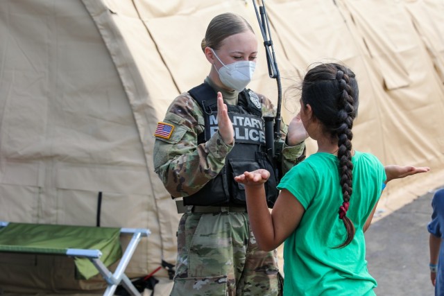 Soldiers from 21st Theater Sustainment Command provide security and assistance to Afghan evacuees at the transit area known as pod 51 on Ramstein Air Base September 9, 2021. The transit center provides a safe place for the evacuees to complete...