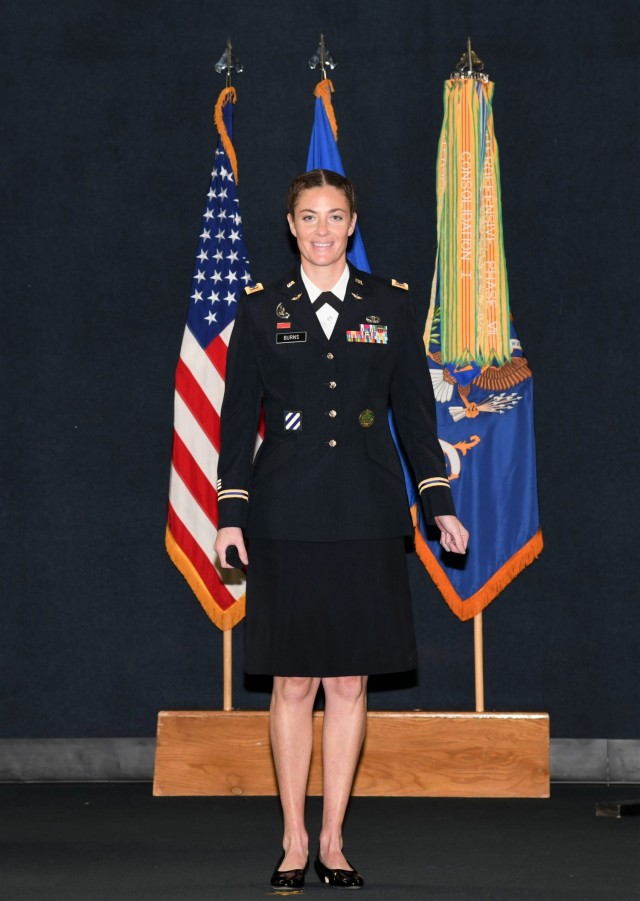 U.S. Army Warrant Officer Jessica L. Burns stands for a photo on stage as she graduates flight school at the U.S. Army Aviation Museum at Fort Rucker, Alabama, October 7, 2021. Burns was one of the Army's first female drill sergeants at Sand Hill, Fort Benning, Georgia. (U.S. Army photo by Kelly Morris)