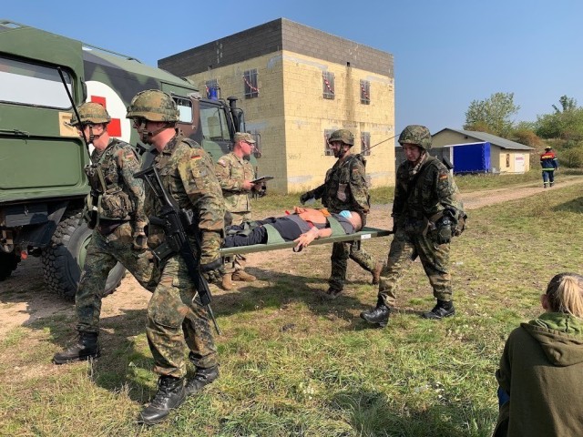 The first responders carry a volunteer cadet to the medic’s vehicle. (Photo courtesy of the Civil Air Patrol Public Affairs Office).