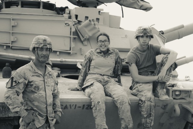 Sgt. 1st Class Richard Martinez (left), Spc. Cinthia Ramirez (middle), and Pfc. Russle (right), all with 1st Cavalry Division, pose for a photo, Fort Hood, Texas, July 21, 2021. The crew shot the highest in the company during their summer gunnery...