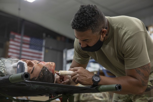 Cpl. Jefet Whyles, a Soldier from the 7305th Brigade Supporting Battalion, applies special effect makeup to a manikin to simulate a head injury at Fort McCoy, Wisconsin, Aug. 13, 2021. These training tools are used in the Combat Support Training...