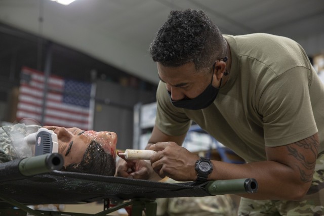 Cpl. Jefet Whyles, a Soldier from the 7305th Brigade Supporting Battalion, applies special effect makeup to a manikin to simulate a head injury at Fort McCoy, Wisconsin, Aug. 13, 2021. These training tools are used in the Combat Support Training Exercise, which the 78th Training Division is executing this rotation. (US Army Reserve Photo by Sgt. Sarah Martens)