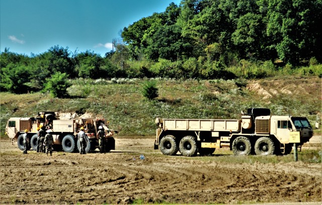 Soldiers at Fort McCoy, Wis., for training in the Regional Training Site-Maintenance Wheeled-Vehicle Recovery Operations Course work together during training Sept. 23, 2021, at the installation Vehicle Recovery Site on North Post. The 17-day course covers operation and maintenance of recovery vehicles and use of standard procedures to rig and recover wheeled vehicles. Related training tasks include oxygen and acetylene gas welding; boom and hoist operations; winch operations; and recovery of mired, overturned, and disabled vehicles. RTS-Maintenance holds several sessions of the Wheeled-Vehicle Operations Course each year and trains Soldiers from both active- and reserve-component forces. (U.S. Army Photo by Scott T. Sturkol, Public Affairs Office, Fort McCoy, Wis.)