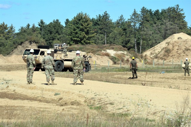 Soldiers at Fort McCoy, Wis., for training in the Regional Training Site-Maintenance Wheeled-Vehicle Recovery Operations Course work together during training Sept. 23, 2021, at the installation Vehicle Recovery Site on North Post. The 17-day course covers operation and maintenance of recovery vehicles and use of standard procedures to rig and recover wheeled vehicles. Related training tasks include oxygen and acetylene gas welding; boom and hoist operations; winch operations; and recovery of mired, overturned, and disabled vehicles. RTS-Maintenance holds several sessions of the Wheeled-Vehicle Operations Course each year and trains Soldiers from both active- and reserve-component forces. (U.S. Army Photo by Scott T. Sturkol, Public Affairs Office, Fort McCoy, Wis.)