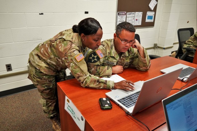 Sgt. Olivia Willis, instructor, clarifies a question on the final exam July 28, 2021, for Staff Sgt. Angel Figueroa during training in the 92Y30 Unit Supply Specialist Course at Fort McCoy, Wis. (U.S. Army Photo by Cheryl Phillips, 88th Readiness...